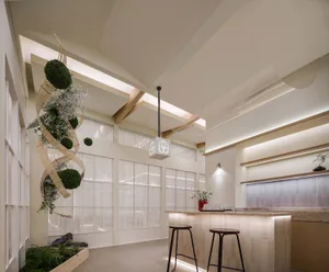 Minimalist interior design featuring wooden furnishings, glass accents, and concrete elements.