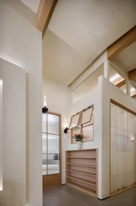 Minimalist interior design featuring wooden shelves and soft lighting.