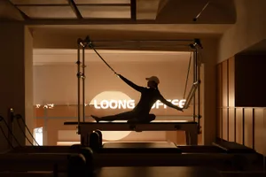 A minimalist exercise room with sustainable wood flooring, designed to promote health and wellness.