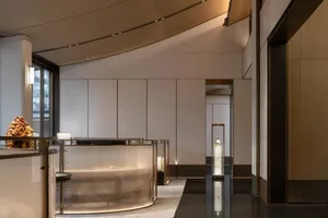Modern lobby featuring glass and marble elements for luxurious design