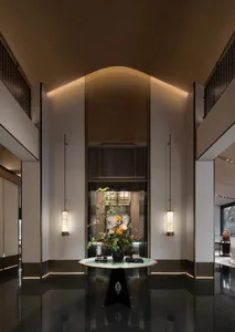 Modern lobby with marble floor, glass walls, and metal accents.