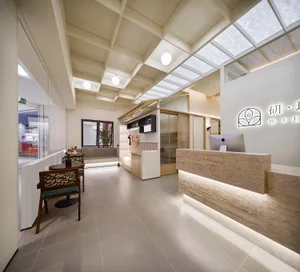 A modern reception desk with a concrete countertop and minimalist design.