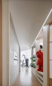 A modern residential interior with minimalist design, featuring a sleek gym area, natural lighting, and a red bear雕塑.