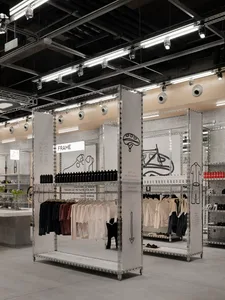 Modern retail store with metal frames displaying clothing and accessories