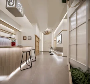A modern spa interior featuring glass walls, minimalist design, and clean lines.