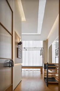 A minimalist exercise studio with wooden flooring and equipment.