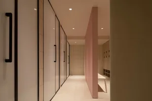 Modern minimalist interior with glass and concrete walls, providing a sleek and contemporary aesthetic.