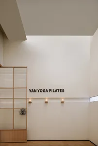 A minimalist yoga studio with glass paneling and white walls