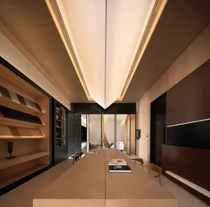 Modern dining room with wooden furniture and ceiling lights.
