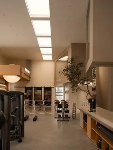 An interior view of a modern fitness center with contemporary design features and equipment.