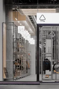 Industrial storefront featuring metal shelving units and concrete support beams