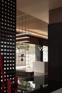 A modern interior design featuring glass walls and concrete flooring in a living room setting.