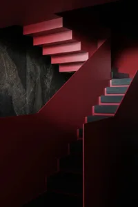 Modern interior design featuring a sleek, floating staircase made of metal