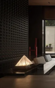 A modern living room with a concrete wall, black accents, and a white sofa.