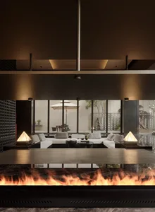 A modern living room featuring large glass walls and a cozy seating arrangement with white sofas and coffee tables.