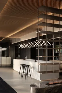 A modern residential kitchen with minimalist design features and mixed materials.
