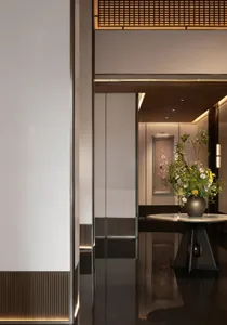 A minimalist hotel entrance featuring black glass panels.