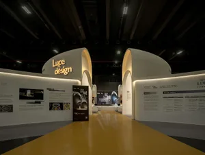 Luce Design exhibition space with white curved structures and illuminated signage