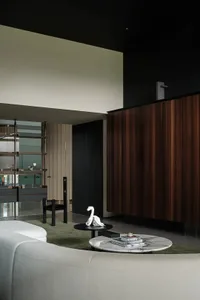A stylish modern minimalist living room featuring clean lines, wood and marble finishes, and a comfortable fabric sofa.