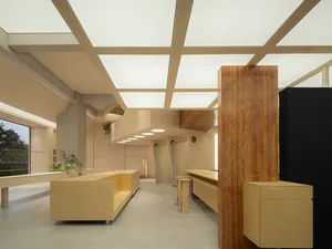 A minimalist commercial interior featuring wood elements and a modern design.