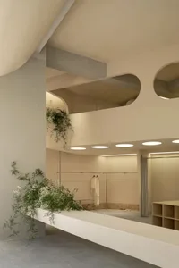 A minimalist storefront featuring natural stone elements.