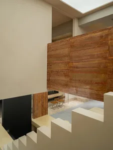 Modern, contemporary interior space featuring exposed concrete columns and polished marble accents.
