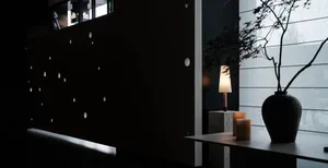 A modern living room featuring a glass wall and a cozy seating area.