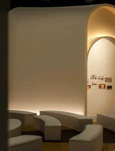 Modern public space features plaster walls and curved seating arrangements