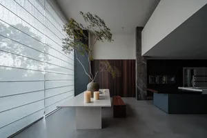 Modern kitchen with concrete and marble materials.