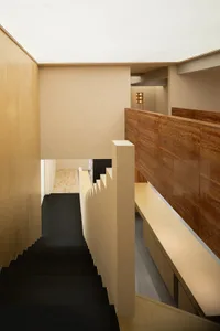 Modern minimalist interior with a black staircase and wooden walls
