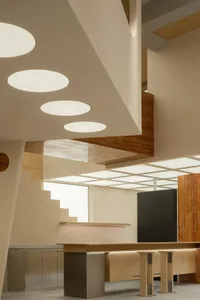 Modern coffee shop interior featuring a mix of wood and concrete materials.