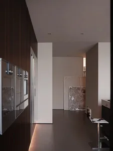 A modern residential kitchen with dark wooden cabinets and glass appliances.