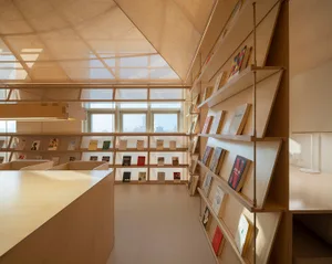 A cozy wooden reading room with shelves full of books and study desks.