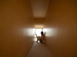 A minimalist interior design featuring wooden walls in a narrow hallway.