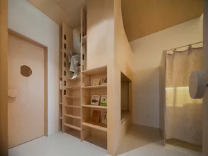 A minimalist bedroom featuring wooden storage units and a bed.