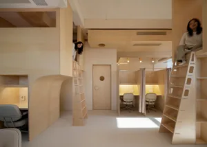 A minimalist office space with wooden furniture and walls.