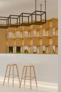Contemporary bar area featuring wooden stools and square cubed shelves.
