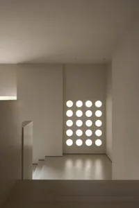 A modern minimalist living space featuring multiple circular glass panels.