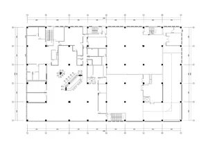 A detailed 2D architectural drawing of a modern office floor plan with a concrete floor and bare surroundings.