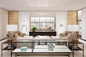 A luxurious fashion store interior featuring high-end furniture with textured cloth and leather finishes, showcasing elegant 
