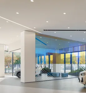 Modern interior of a car dealership featuring large glass windows