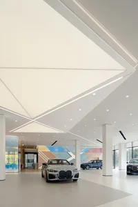 A modern showroom with cars displayed in a spacious, contemporary setting.