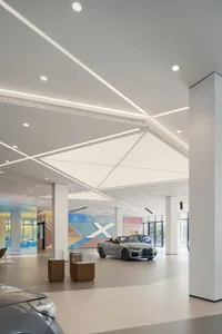 A modern car showroom featuring contemporary design elements and a sleek, minimalist aesthetic.
