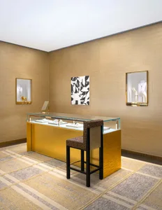 Luxury jewelry display featuring gold-accented stainless steel fixtures