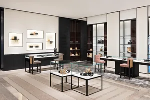 A luxurious retail shop showcasing minimalist design with glass display cases, wood furniture, and metal accents.