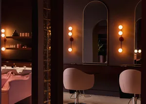 Industrial-themed salon with glass, metal, and leather accents