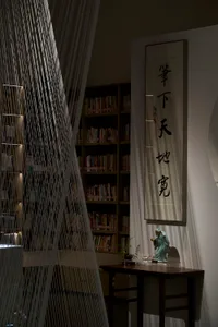 A modern library with a bookshelf display featuring various books.