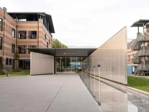 A modern office building exterior with metallic and glass architectural elements.