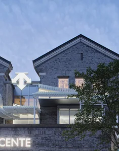 A contemporary brick building with large glass windows and a modern design.