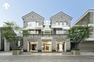 A modern retail storefront with brick and concrete exterior, aluminum frames, and a modern design aesthetic.